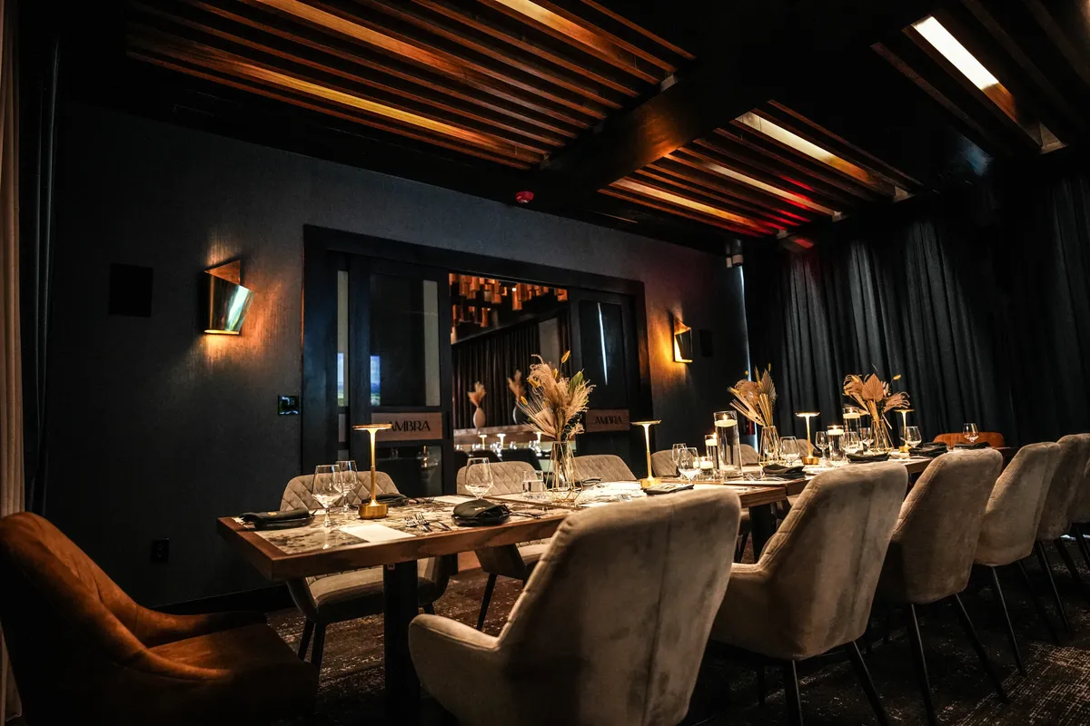 Ambra's private dining room set for a long table under slatted wood