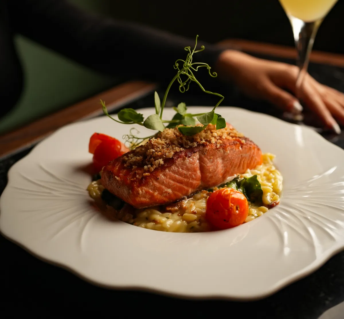 Grilled salmon over risotto with blistered tomatoes