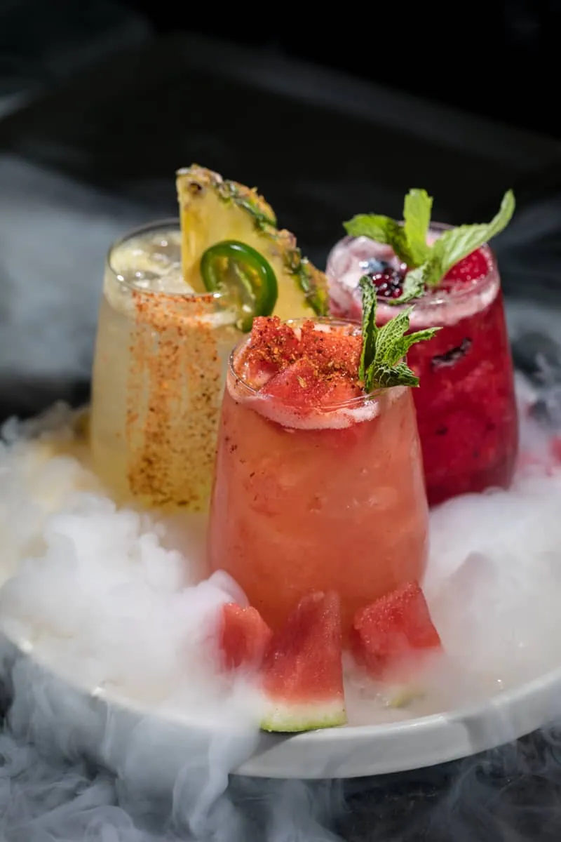 Trio of craft cocktails served over dry ice