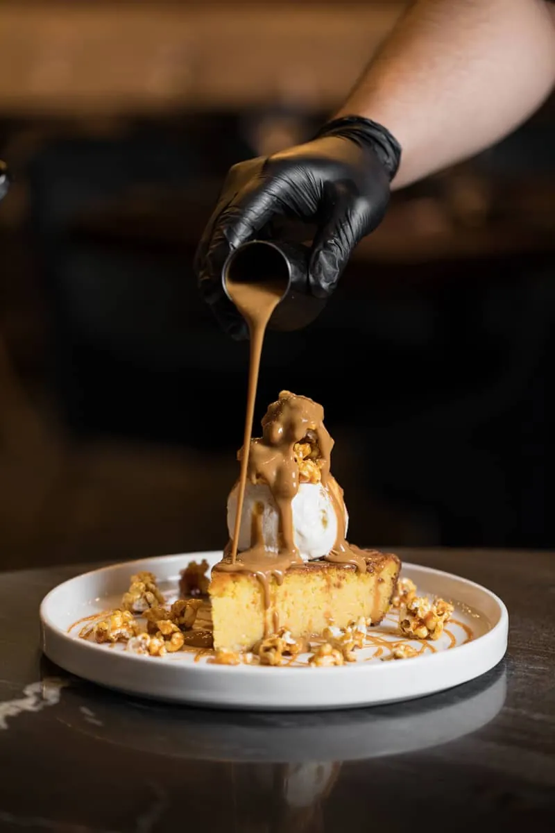Warm dessert with caramel sauce poured tableside