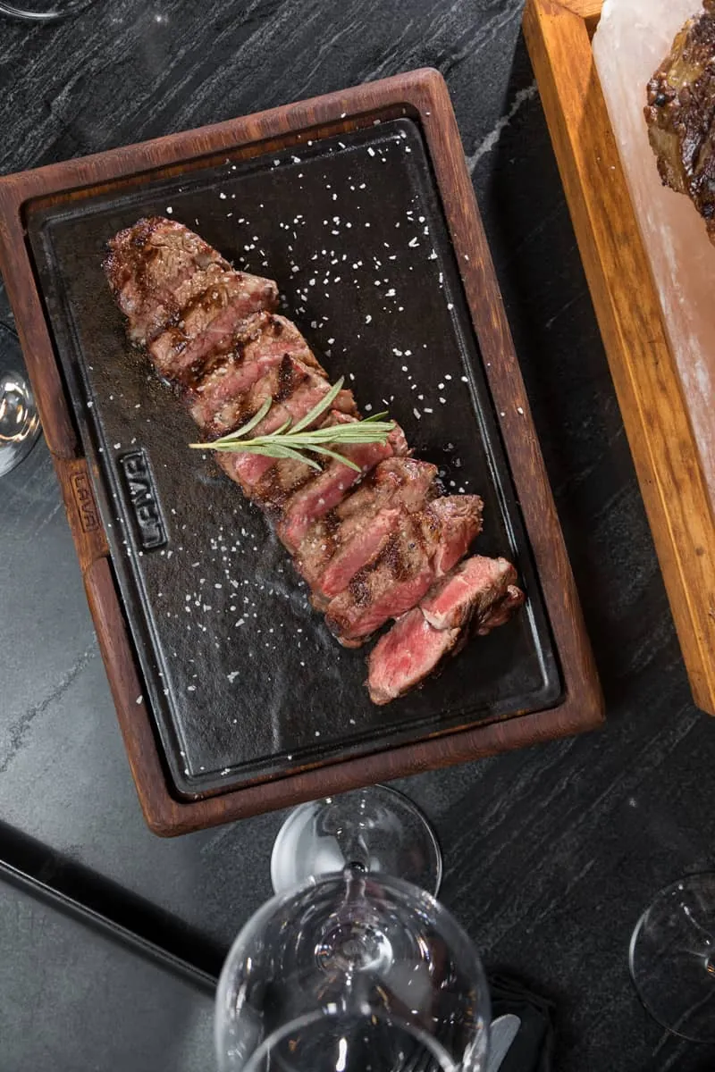 Sliced grilled steak on a hot stone
