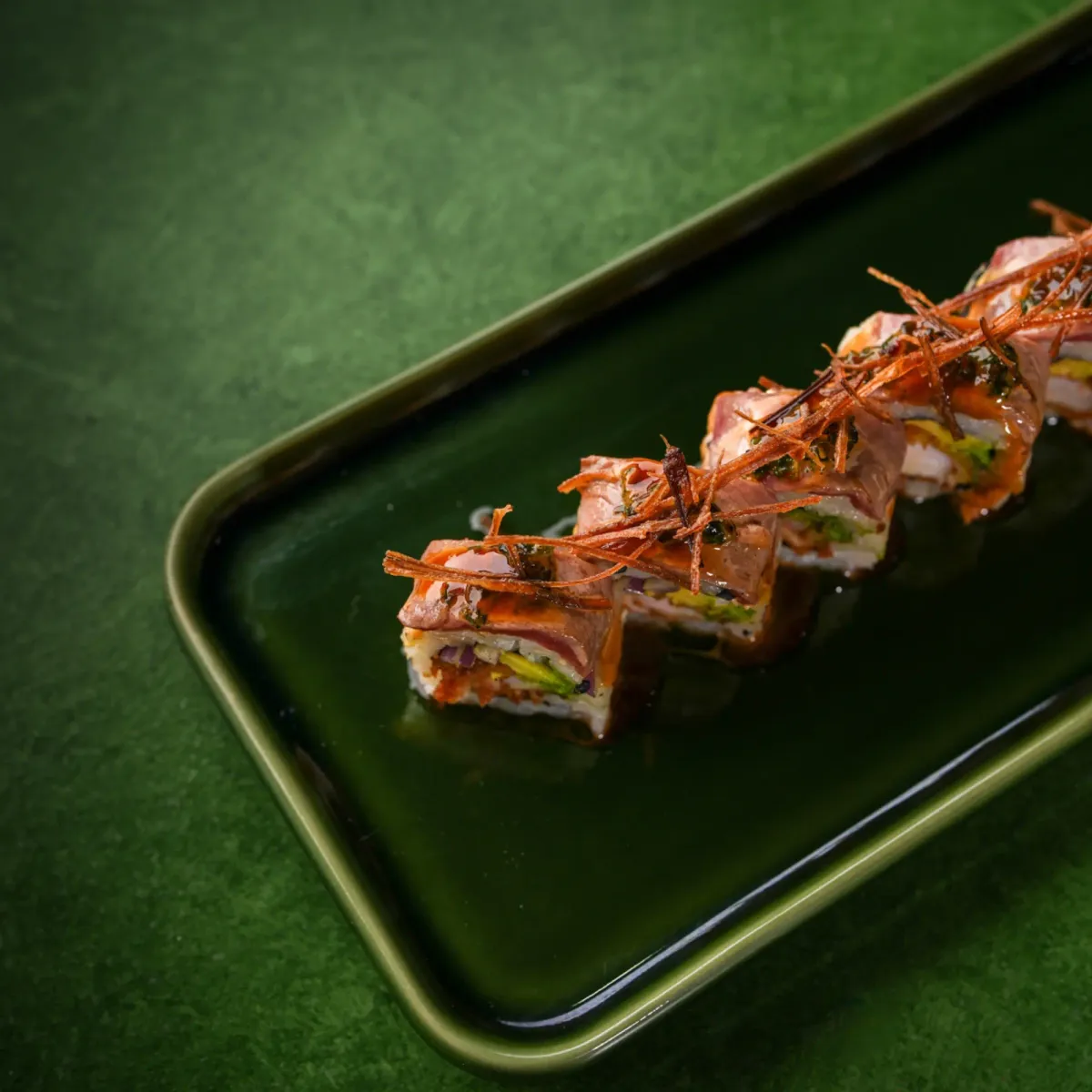 Nikkei roll topped with crispy sweet-potato threads