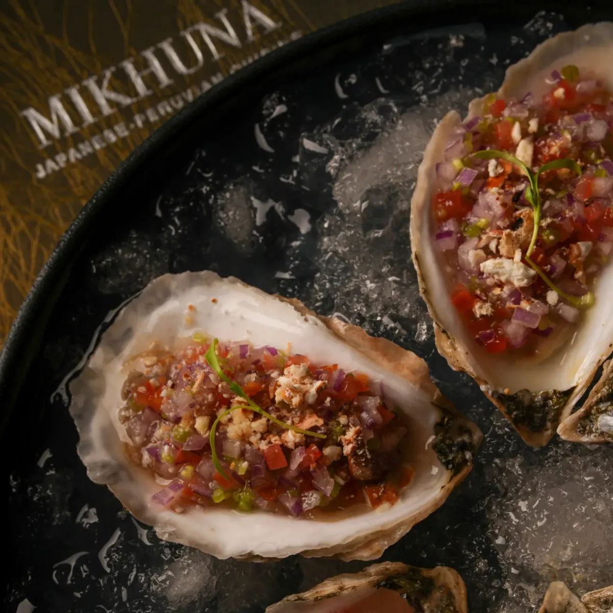 Oysters on the half shell dressed with leche de tigre and red onion