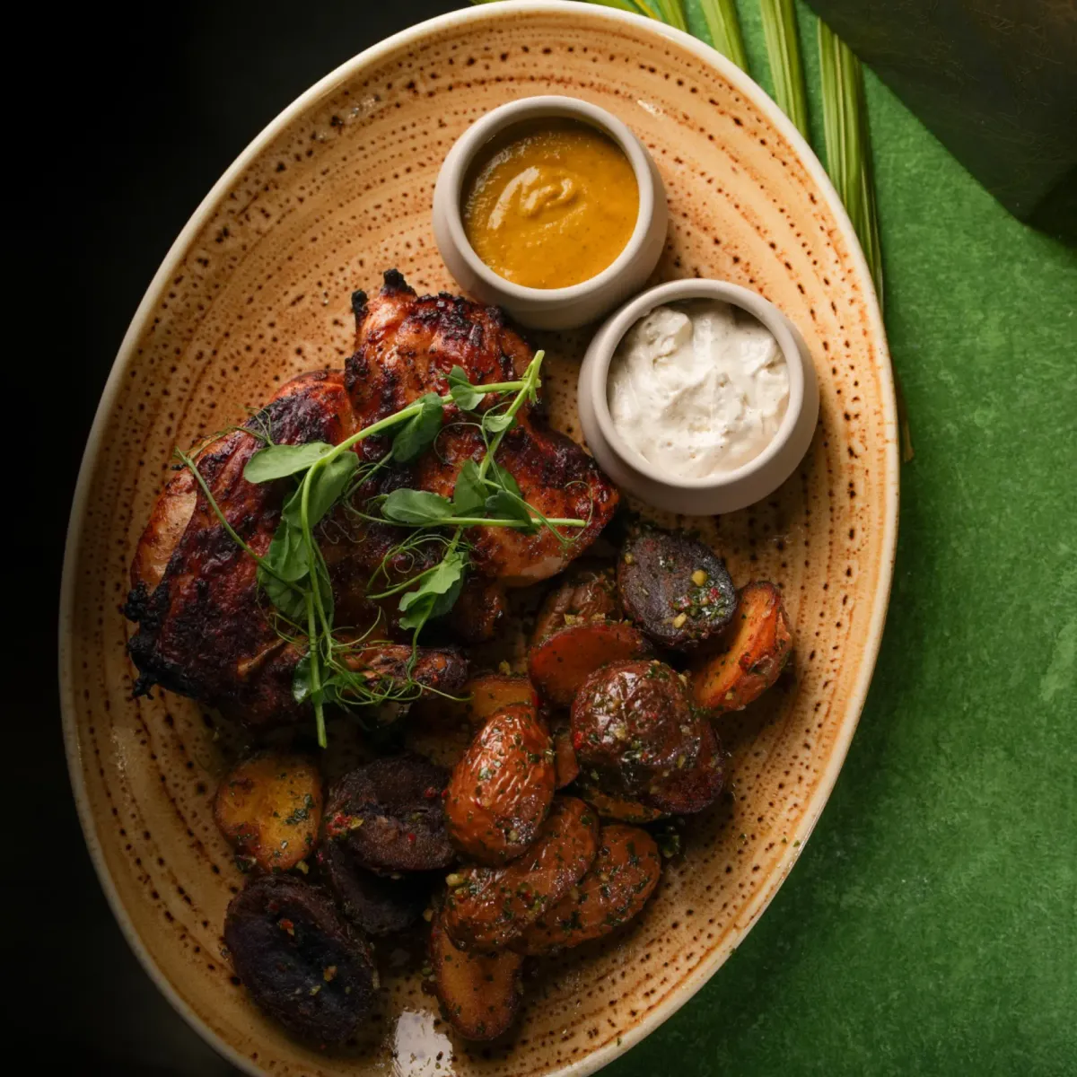 Grilled chicken anticuchos with roasted potatoes, ají amarillo and huancaína sauces