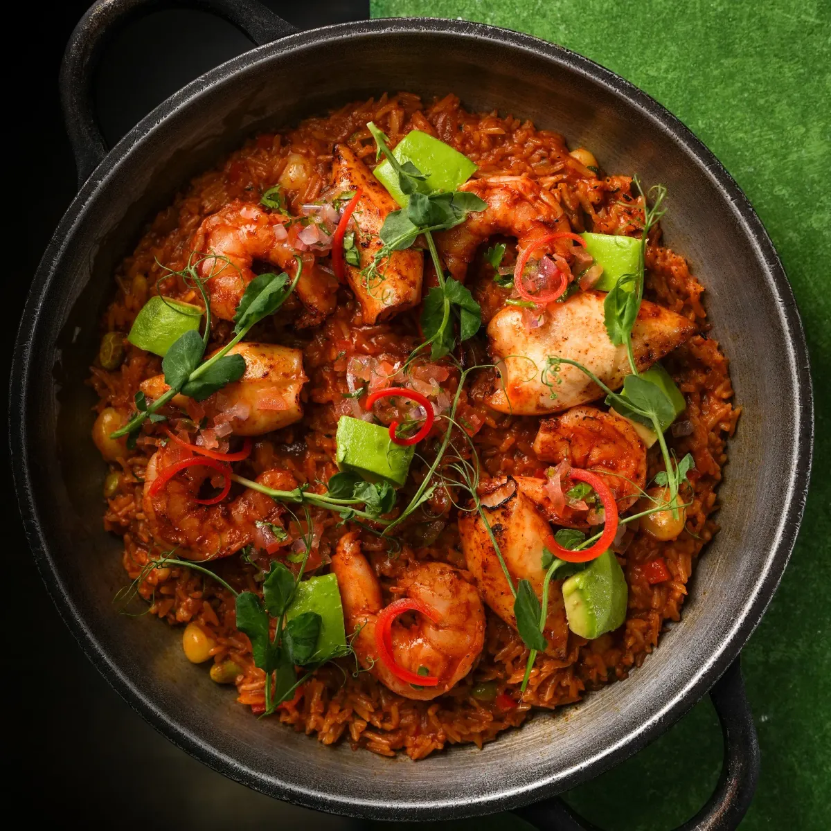 Peruvian seafood rice with shrimp and calamari in a cast-iron pan