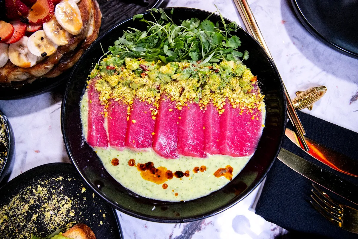 Aguachile verde with sliced ahi tuna and pistachio, shot from above