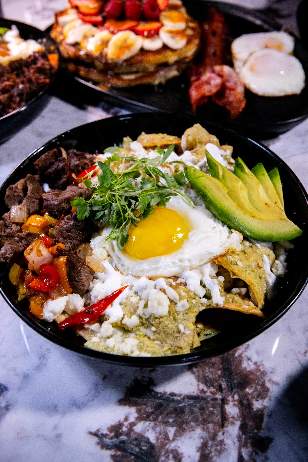 Chilaquiles de ribeye with a fried egg and avocado from the Sunday brunch menu
