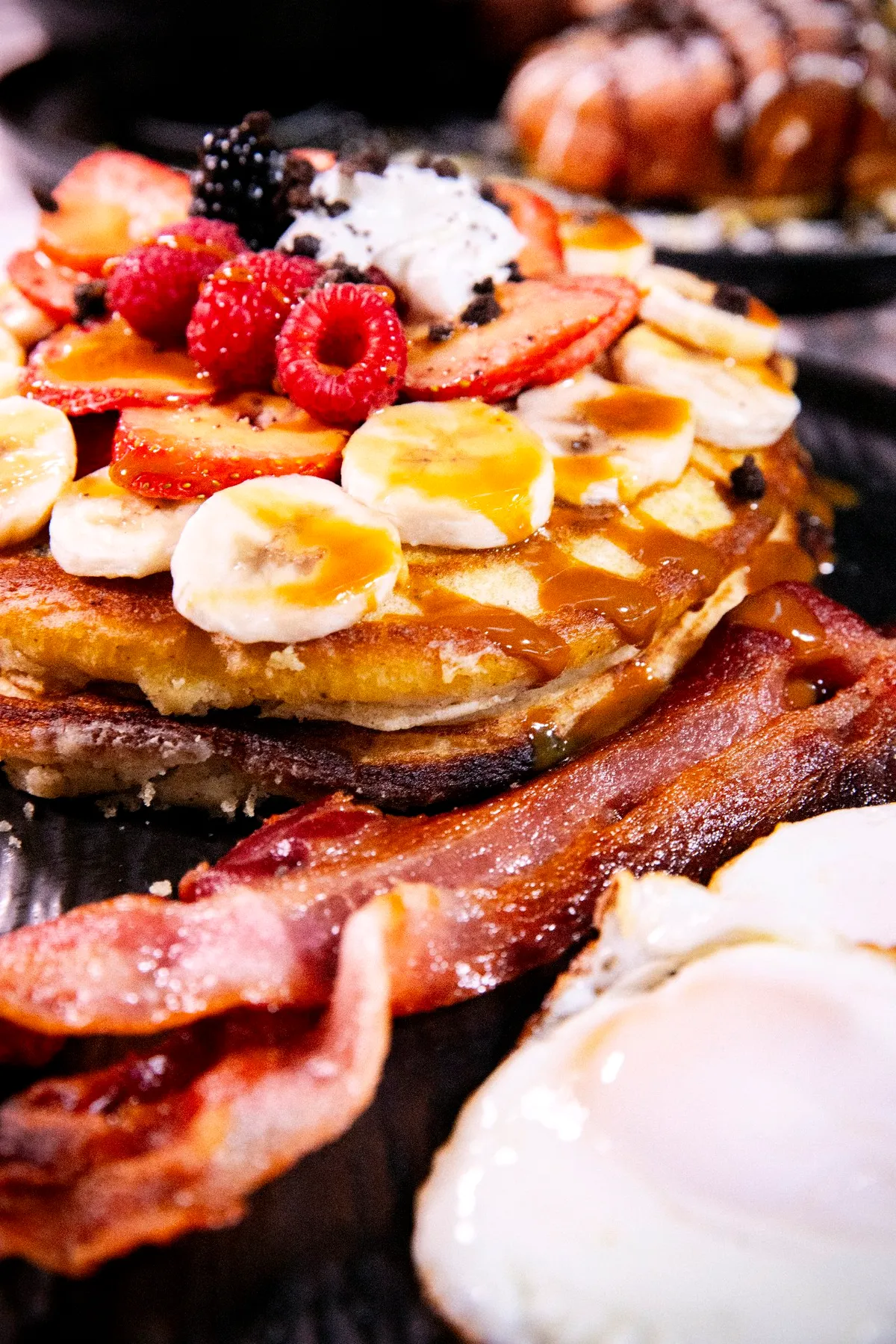 Oreo pancakes stacked with berries, banana and caramel