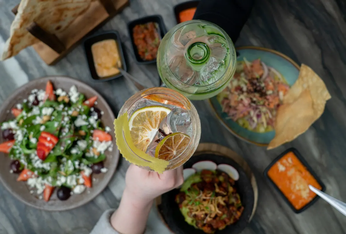 Overhead of salads, salsas and cocktails at a Palominos table