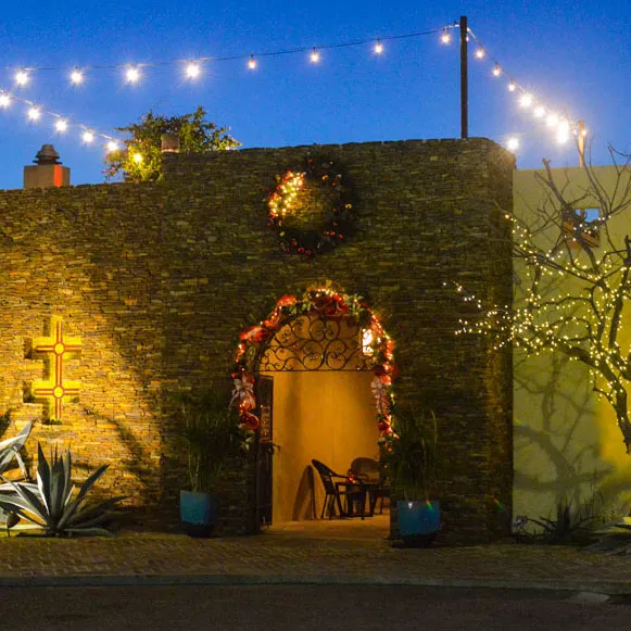 The lantern-lit courtyard entrance and archway at Santa Fe Steakhouse & Cantina