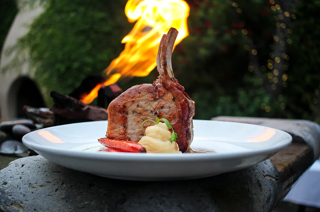 Bone-in chop flambéed tableside on the patio