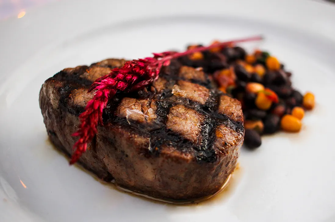 Char-grilled filet with cross-hatch grill marks and roasted vegetables