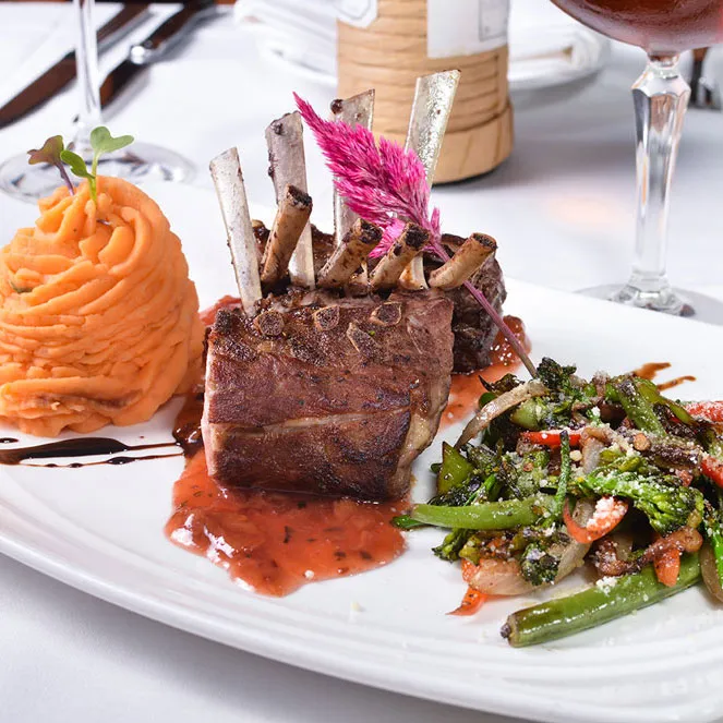 Rack of lamb with sweet potato purée and a glass of red wine