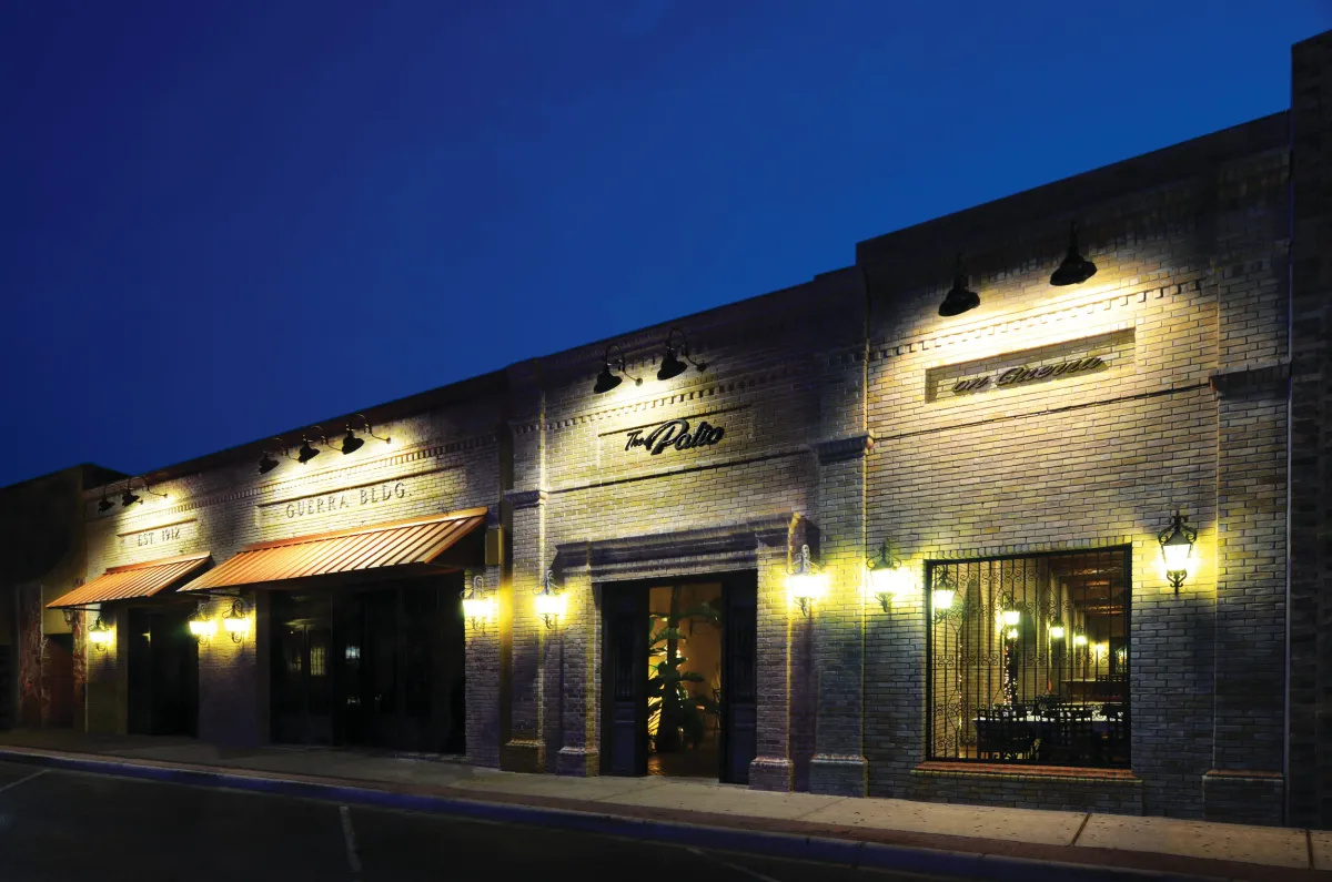 The Patio on Guerra's historic storefront on 17th Street at dusk