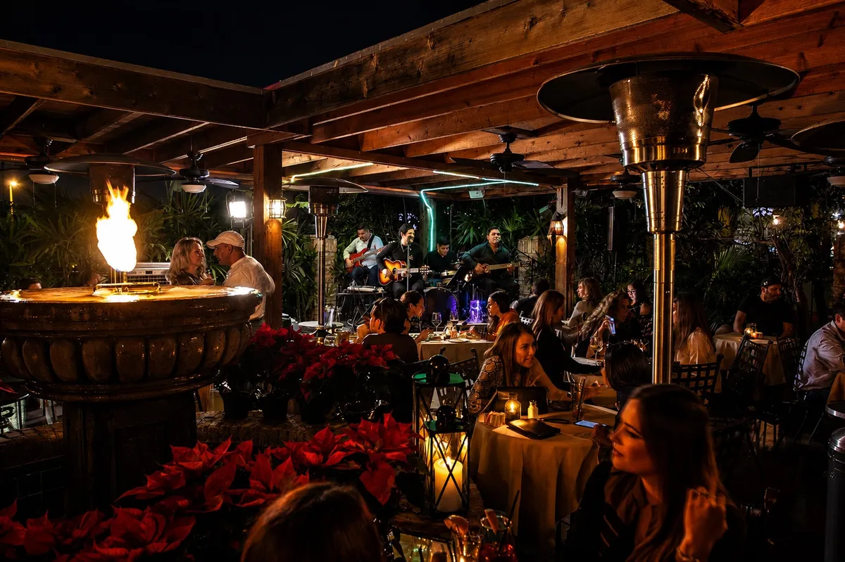 Diners on the patio around the fire feature at night