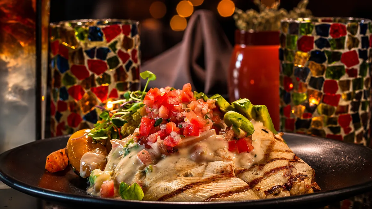 Avocado chicken smothered in queso and pico de gallo